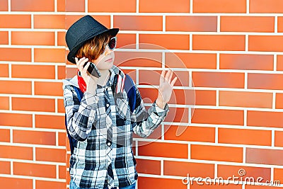 Schoolboy using phone outside school. Technology, education and lifestyle concept Stock Photo