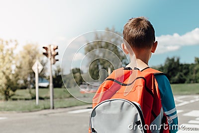 Schoolboy waiting at zebra crossing Stock Photo