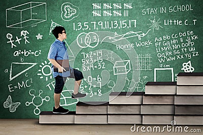 Schoolboy walks on books stair with doodle Stock Photo