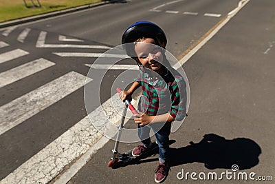Schoolboy wearing a cycling helmet on a pedestrian crossing Stock Photo