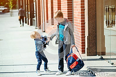 Schoolboys with backpack going to school. Stylish brothers outdoors. Primary school Stock Photo