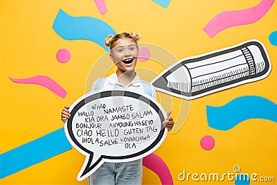 Schoolchild holding speech bubble with greeting Stock Photo