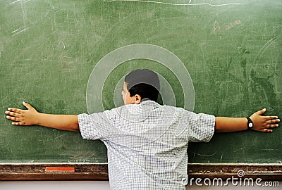 Schoolchild hugging board Stock Photo