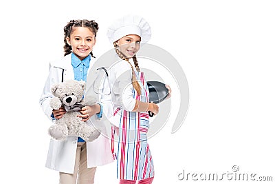 schoolchildren in costumes of doctor and chef standing in white coat and apron Stock Photo