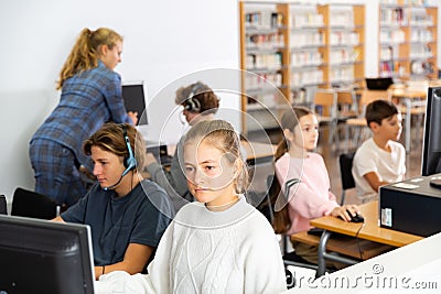 Schoolchildren preparing for lessons on the computer Stock Photo