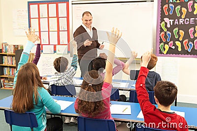 Schoolchildren Studying In Classroom With Teacher Stock Photo