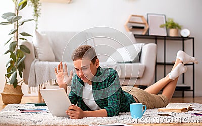 Schooler having videochat on digital tablet from home Stock Photo