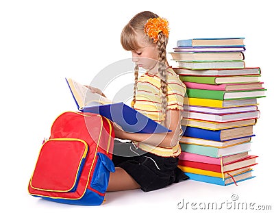 Schoolgirl with backpack reading pile of books. Stock Photo