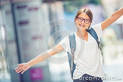 Schoolgirl with bag, backpack. Portrait of modern happy teen school girl with bag backpack. Girl with dental braces and glasses Stock Photo
