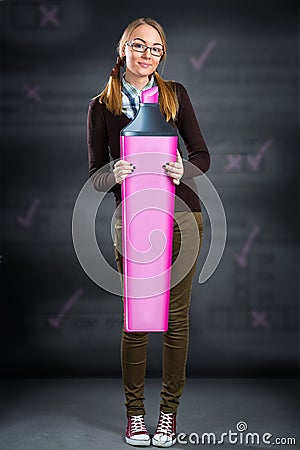 Schoolgirl with big marker thinking on exam Stock Photo