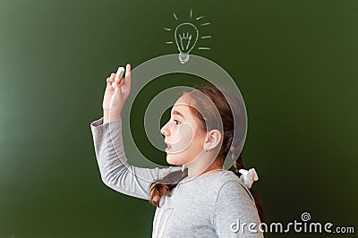 A schoolgirl at the blackboard was able to find solution to the problem. inspiration. the idea came Stock Photo