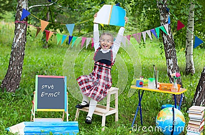 Schoolgirl child kid girl stay on chair holding book notebook ab Stock Photo