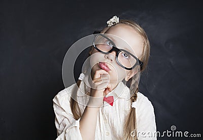 Schoolgirl Child Thinking and Looking Up. Back to School Stock Photo