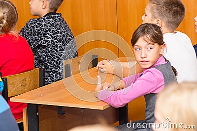 Schoolgirl in class at the Desk Editorial Stock Photo