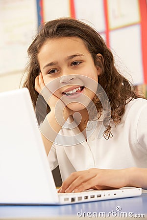 Schoolgirl In IT Class Using Computer Stock Photo