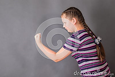 A schoolgirl girl full of determination threatens someone Stock Photo