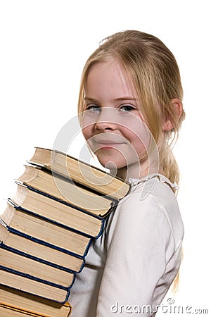 Schoolgirl holding pile of books Stock Photo