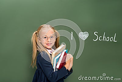 Schoolgirl with pile of books next Stock Photo