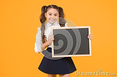 Schoolgirl pupil informing you. School girl hold blank chalkboard copy space. Announcement and promotion. Check this out Stock Photo