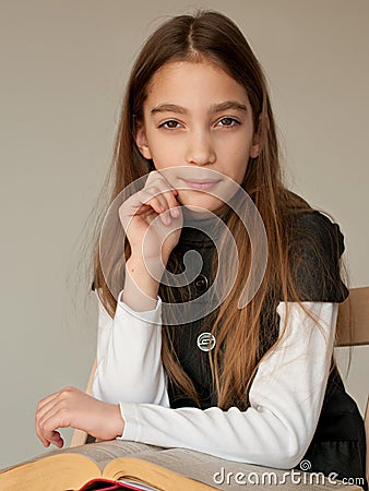 Schoolgirl reading big book Stock Photo