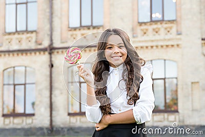 Schoolgirl relaxing. School nutrition. Sugar diet. Sweet joy. Happy kid with sweet candy. Happy childhood. Kid child Stock Photo