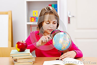 Schoolgirl searching with magnifier Stock Photo