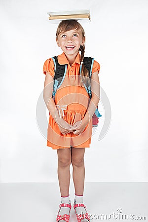 Schoolgirl with a textbook on her head Stock Photo