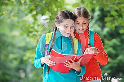 Schoolgirls with backpacks and textbooks, forest school concept Stock Photo