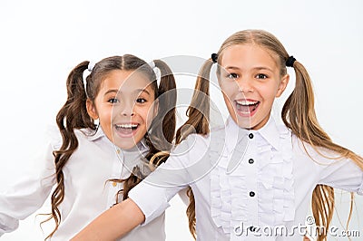 Schoolgirls with cute ponytails hairstyle and brilliant smiles. Best friends excellent pupils. Perfect schoolgirls tidy Stock Photo