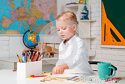 Schoolkid or preschooler learn. Child near chalkboard in school classroom. Chalkboard copy space. Home schooling. Stock Photo