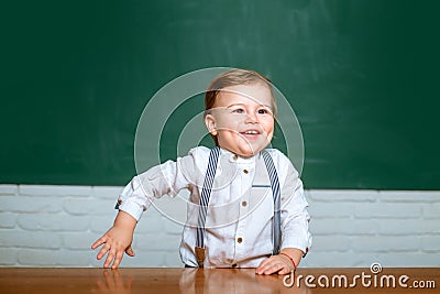 Schoolkid or preschooler learn. Elementary school. Cute preschooler with funny face schooling work. Portrait of Stock Photo