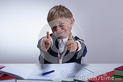 Schoolkid showing thumbs up Stock Photo