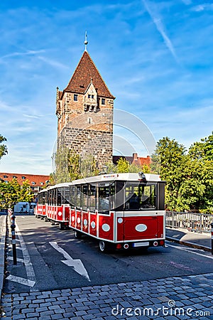Schuldturm tower with city train on the bridge in Nuremberg, Germany Editorial Stock Photo