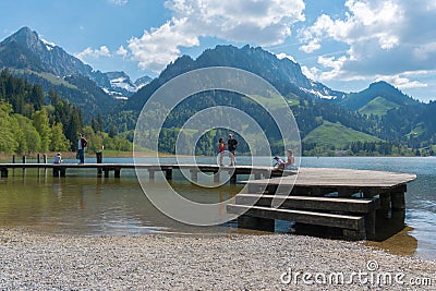 Schwarzsee, FR / Switzerland - 1 June 2019: tourist people enjoy a visit to Lake Schwarzsee in Fribourg as a family vacation Editorial Stock Photo