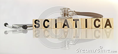 SCIATICA the word on wooden cubes, cubes stand on a reflective white surface, on cubes - a stethoscope Stock Photo