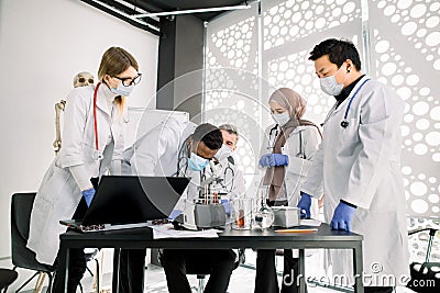 Science, chemistry, medicine, immunology concept. Young multiracial scientists making test or research in clinical Stock Photo