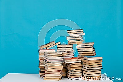 science education stack of books on a blue background teaching literacy Stock Photo