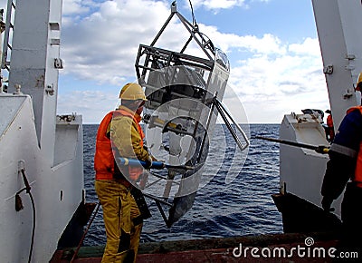 The Sea of Japan / Russia - December 01 2013: Science expedition team recovering the epibenthic sledge Editorial Stock Photo