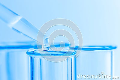 Science laboratory test blue tubes, macro flask equipment. Chemical dropper Stock Photo