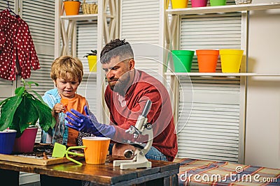 The science of plants. Biology. The teacher teaches the boy how to care for home plants. Stock Photo