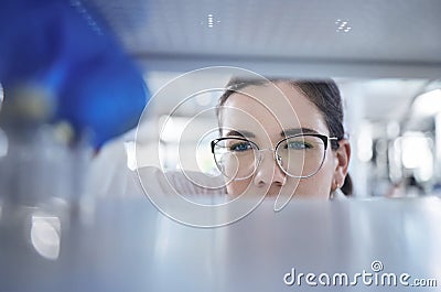 Science, search and the eyes of a woman in a laboratory for research, innovation or medical storage. Healthcare, medical Stock Photo