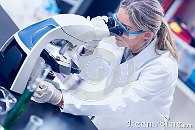 Science student looking through microscope in the lab Stock Photo