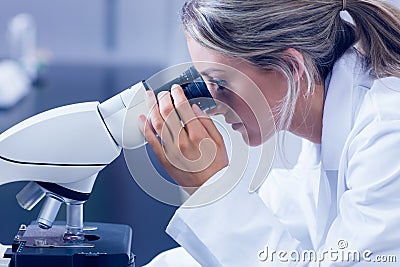 Science student looking through microscope in the lab Stock Photo