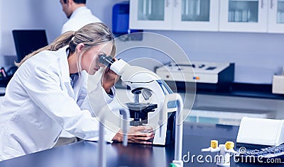 Science student looking through microscope in the lab Stock Photo