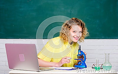 Scientific research. Microbiology concept. Student girl with laptop and microscope. Molecular biology PhD projects Stock Photo