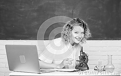 Scientific research. Microbiology concept. Student girl with laptop and microscope. Molecular biology PhD projects Stock Photo