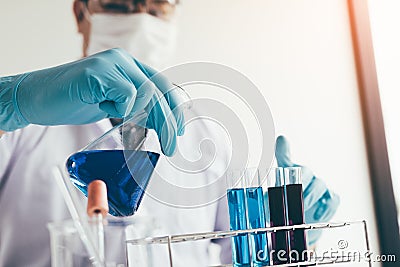 Scientific researcher or doctor pouring chemical substance test tube in laboratory Stock Photo