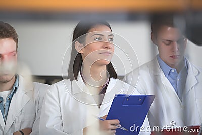 Scientific researcher holding a folder of chemical experiment research.Science students working with chemicals in the lab at the u Stock Photo