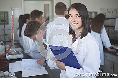 Scientific researcher holding a folder of chemical experiment research. Science students working with chemicals in the lab at the Stock Photo