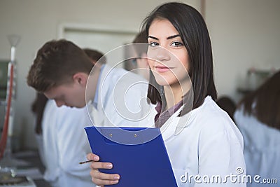 Scientific researcher holding a folder of chemical experiment research. Science students working with chemicals in the lab at the Stock Photo